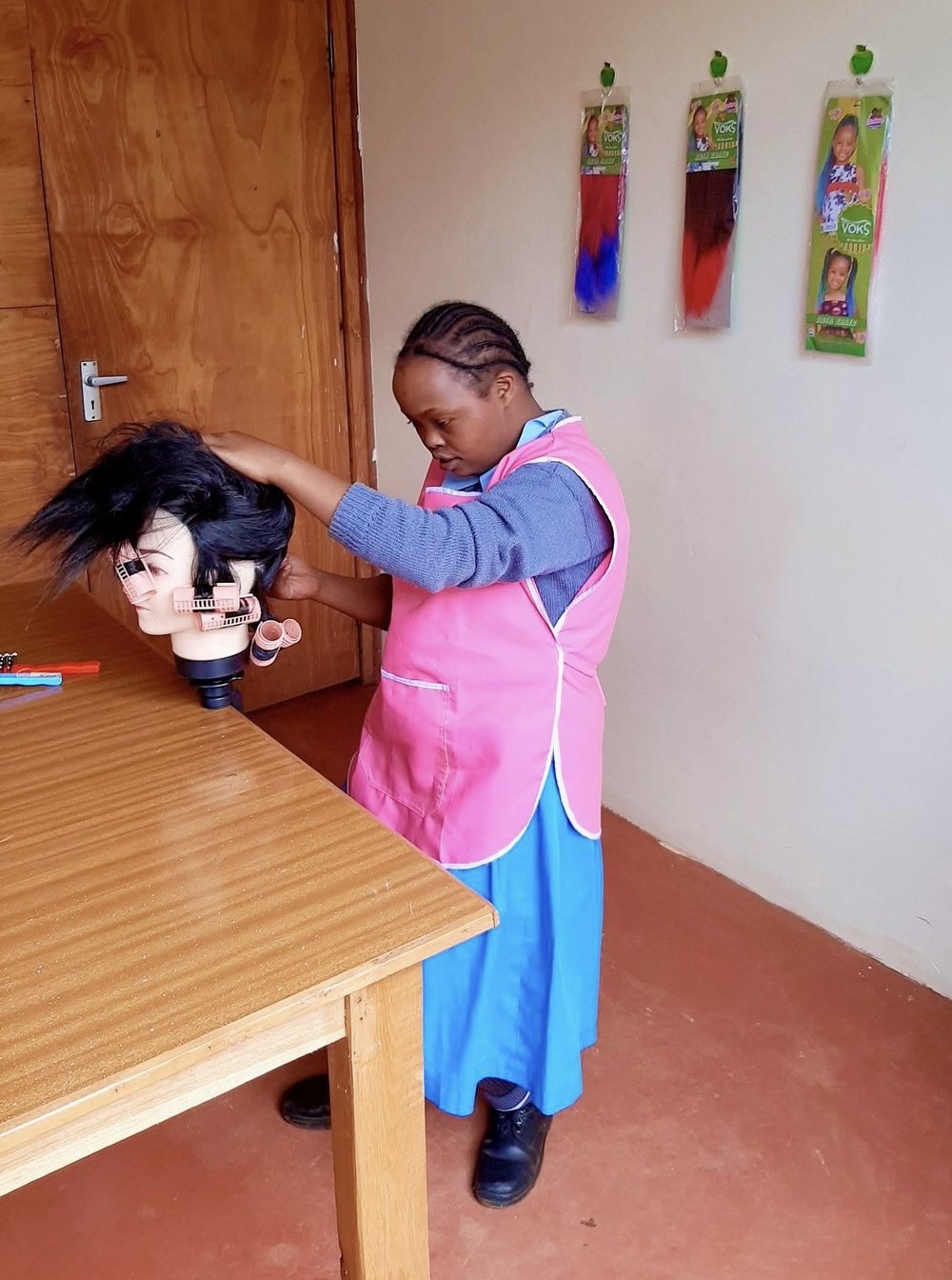 A young person practising hairdressing at the centre