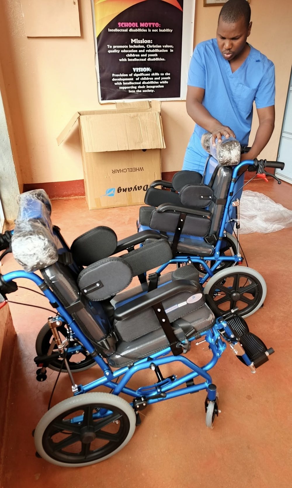 A therapist assembling brand new specialised wheelchairs